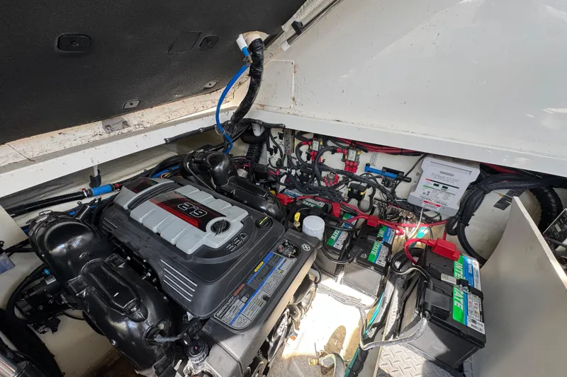 Slide: The Image of Engine compartment of a 2019 Sea Ray Sundancer 320, showcasing the engine and battery setup. - 75