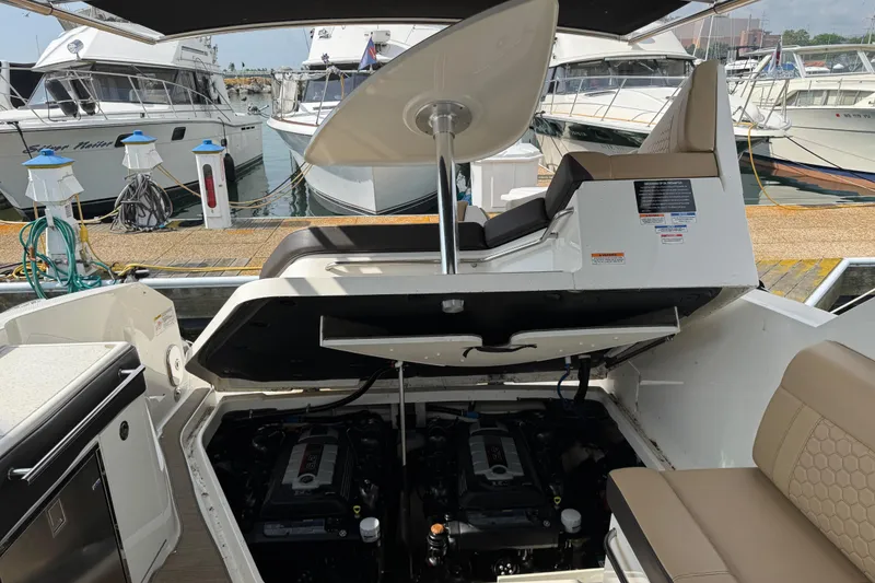 Slide: The Image of 2019 Sea Ray Sundancer 320 engine compartment open at marina dock. - 76