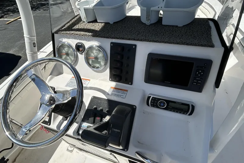 Slide: The Image of 2016 Yamaha Boats 190 FSH Sport dashboard with steering wheel and controls. - 5
