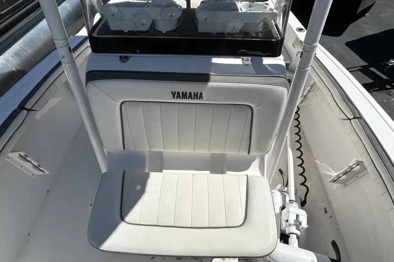 Slide: The Image of 2016 Yamaha Boats 190 FSH Sport interior seating with console and storage. - 6