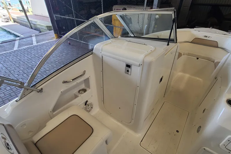 Slide: The Image of 2013 Sea Hunt Escape 234 LE boat interior with seating and windshield. - 17