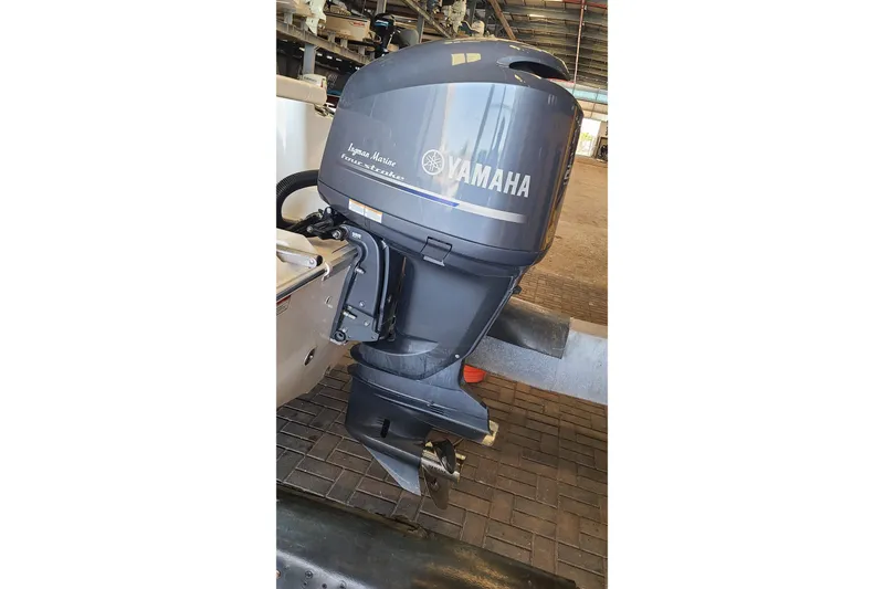 Slide: The Image of Yamaha outboard motor on a 2013 Sea Hunt Escape 234 LE boat in a storage facility. - 29
