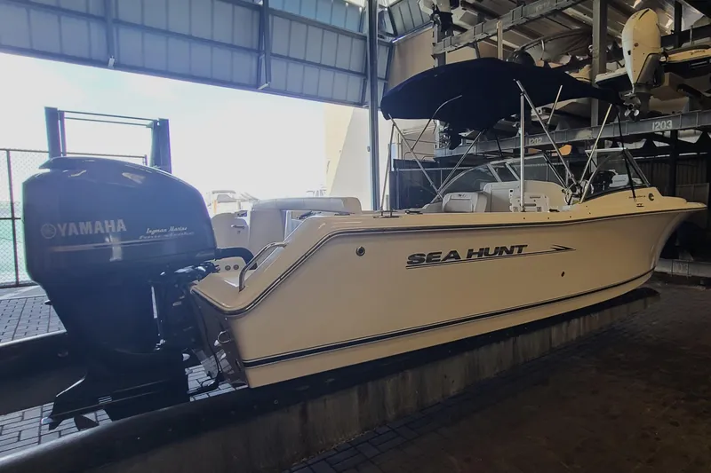 Slide: The Image of 2013 Sea Hunt Escape 234 LE boat with Yamaha engine in storage facility. - 4