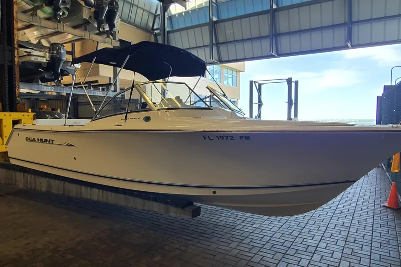 Slide: The Image of 2013 Sea Hunt Escape 234 LE boat in storage facility, side view with canopy. - 5
