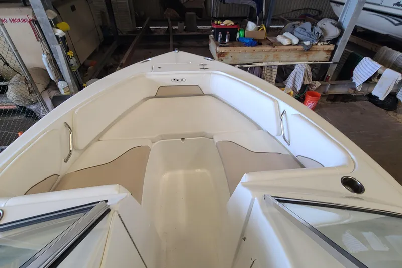 Slide: The Image of 2013 Sea Hunt Escape 234 LE boat interior with beige seating in storage. - 6