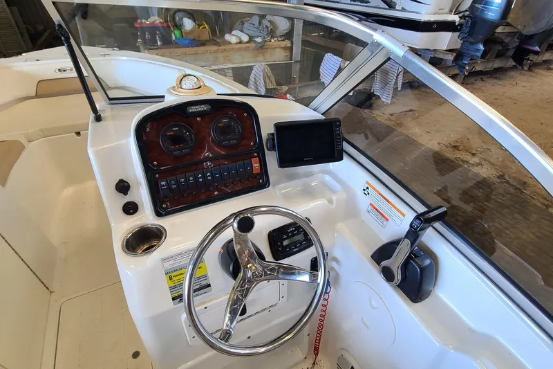 Slide: The Image of 2013 Sea Hunt Escape 234 LE boat dashboard with steering wheel and control panel. - 8