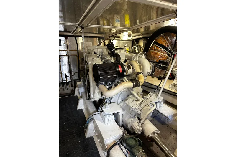 Slide: The Image of Engine room of 2002 McKinna 57 Pilothouse yacht, showcasing mechanical components. - 21