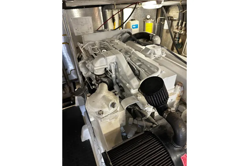 Slide: The Image of Engine room of 2002 McKinna 57 Pilothouse yacht, showcasing detailed machinery components. - 22