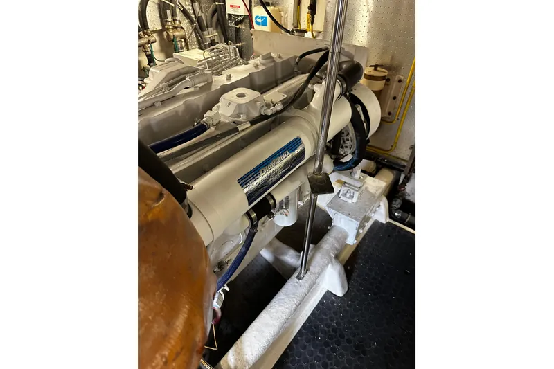 Slide: The Image of Engine room of a 2002 McKinna 57 Pilothouse yacht, showcasing mechanical components. - 23