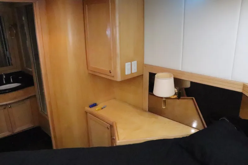 Slide: The Image of Interior of 2002 McKinna 57 Pilothouse yacht with wooden cabinetry and lamp. - 25
