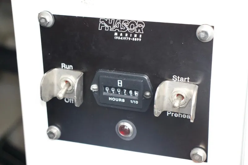 Slide: The Image of Control panel of a 2002 McKinna 57 Pilothouse with hour meter and switches. - 28