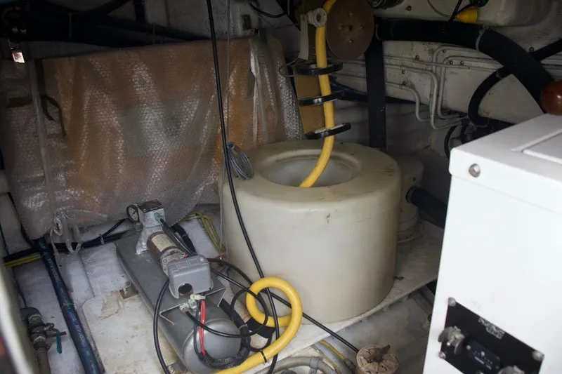 Slide: The Image of Engine room of a 2002 McKinna 57 Pilothouse yacht, featuring mechanical components and wiring. - 30