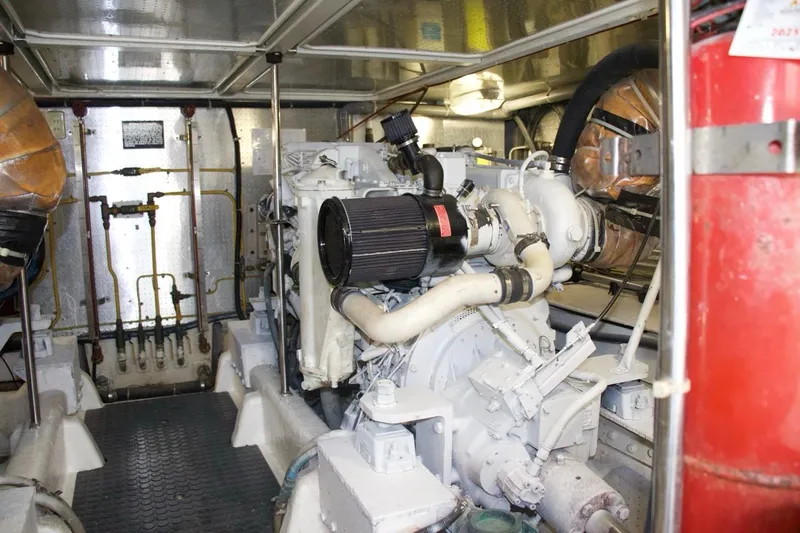 Slide: The Image of Engine room of a 2002 McKinna 57 Pilothouse yacht, showcasing mechanical components. - 32