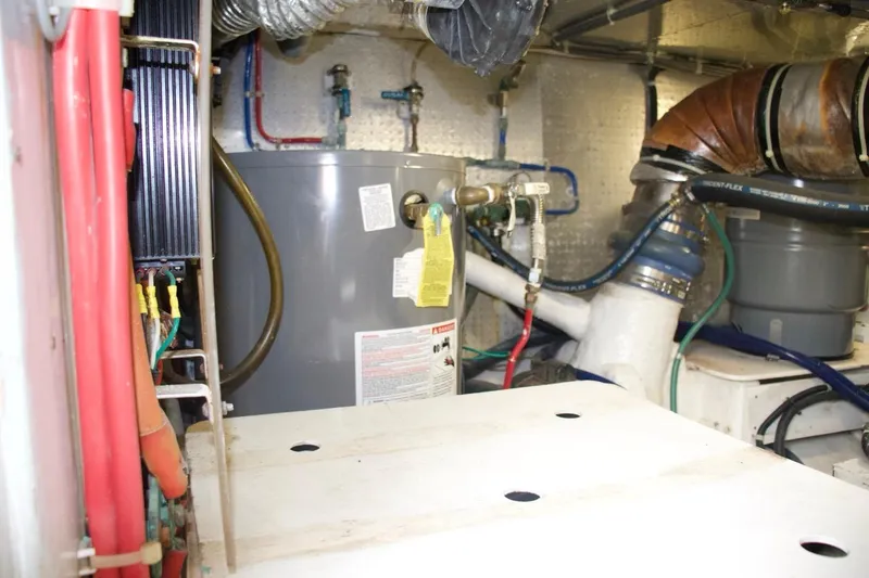 Slide: The Image of Engine room of 2002 McKinna 57 Pilothouse with water heater and piping. - 34