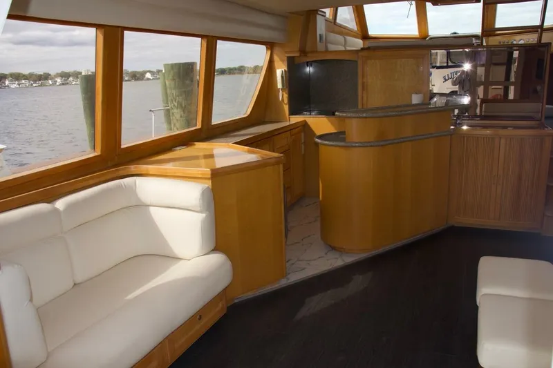 Slide: The Image of Luxurious interior of a 2002 McKinna 57 Pilothouse yacht with elegant wood finishes and waterfront view. - 40