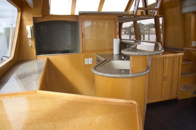 Slide: The Image of Luxurious 2002 McKinna 57 Pilothouse yacht interior with modern kitchen and wooden cabinetry. - 43