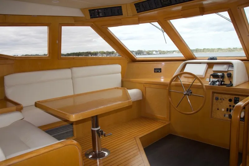 Slide: The Image of Interior of 2002 McKinna 57 Pilothouse yacht with wooden helm and seating area. - 45