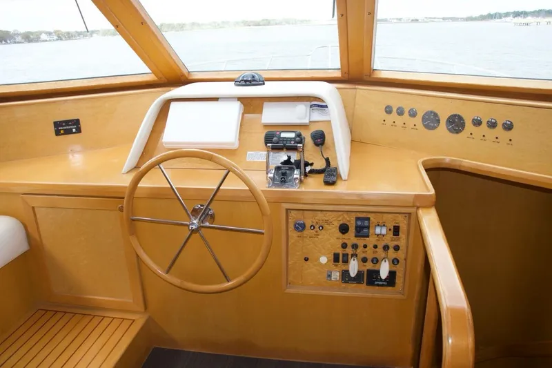 Slide: The Image of Pilothouse interior of 2002 McKinna 57, featuring steering wheel and control panel. - 46