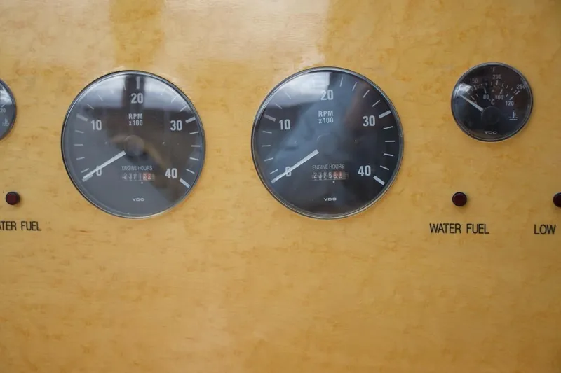 Slide: The Image of Close-up of McKinna 57 Pilothouse 2002 dashboard gauges displaying RPM and engine hours. - 48