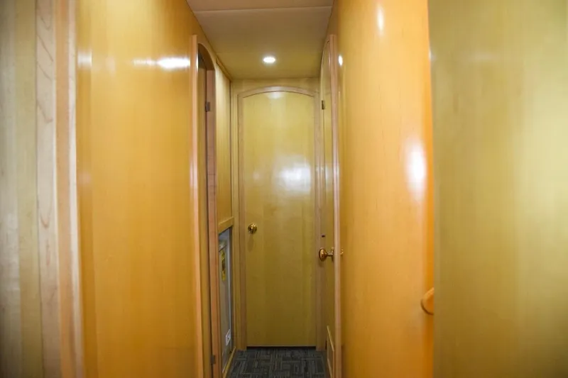 Slide: The Image of Hallway inside 2002 McKinna 57 Pilothouse yacht with wooden walls and carpeted floor. - 54