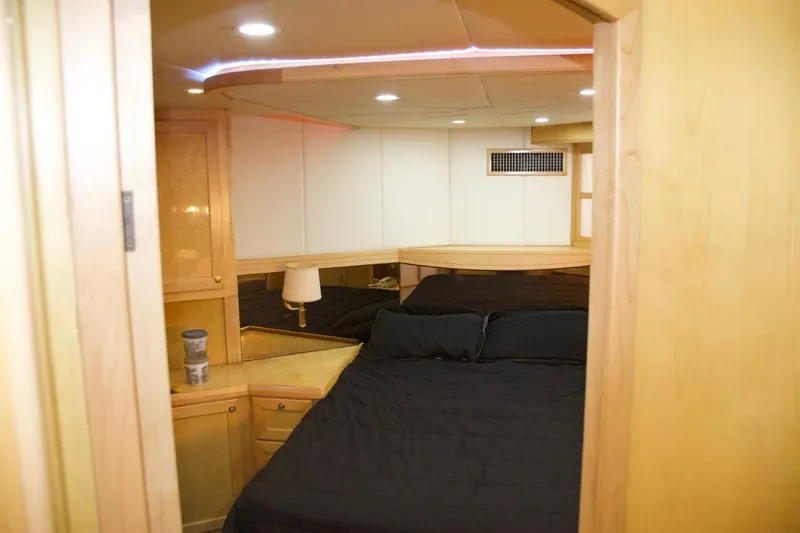 Slide: The Image of Luxurious cabin interior of 2002 McKinna 57 Pilothouse yacht with cozy bed and wooden furnishings. - 56