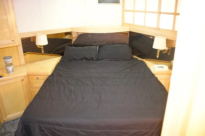 Slide: The Image of Luxurious bedroom interior of 2002 McKinna 57 Pilothouse yacht with black bedding. - 57