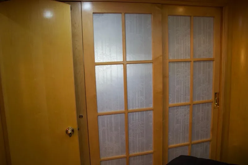 Slide: The Image of Wooden sliding doors with frosted glass panels on a 2002 McKinna 57 Pilothouse yacht. - 60