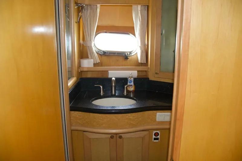Slide: The Image of Bathroom interior of 2002 McKinna 57 Pilothouse yacht with sink and porthole window. - 61