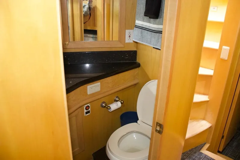 Slide: The Image of Bathroom interior of 2002 McKinna 57 Pilothouse yacht with wooden cabinetry and modern fixtures. - 62