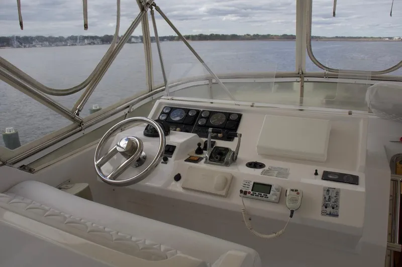 Slide: The Image of Pilothouse of 2002 McKinna 57 yacht with steering wheel and navigation controls. - 64