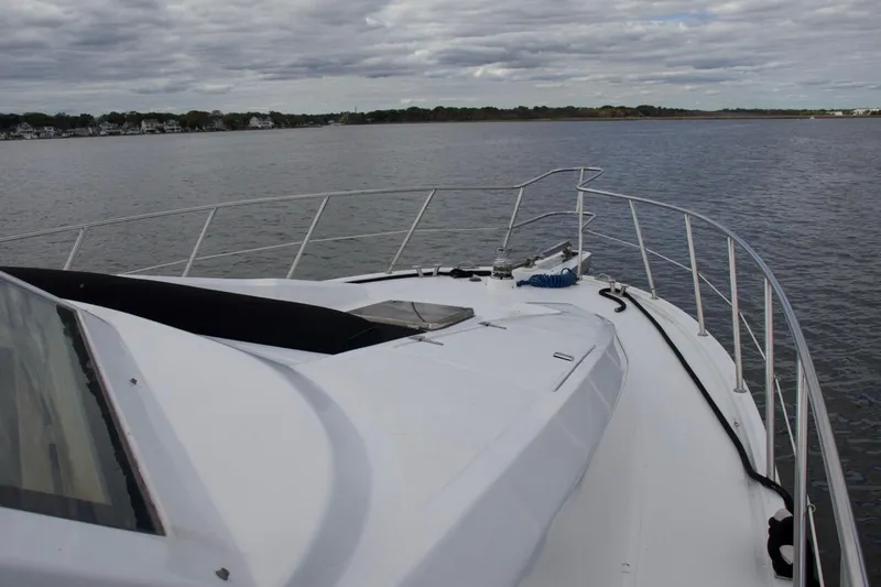 Slide: The Image of 2002 McKinna 57 Pilothouse yacht on calm waters under cloudy skies. - 65
