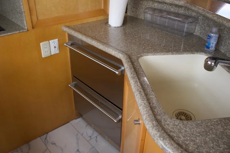 Slide: The Image of Kitchen area of 2002 McKinna 57 Pilothouse with sink and stainless steel drawers. - 66