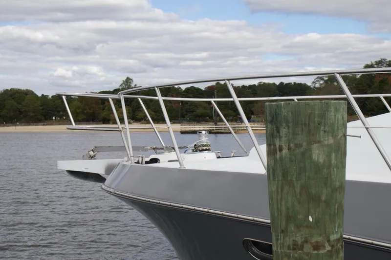 Slide: The Image of Bow of 2002 McKinna 57 Pilothouse yacht docked by a wooden post. - 7