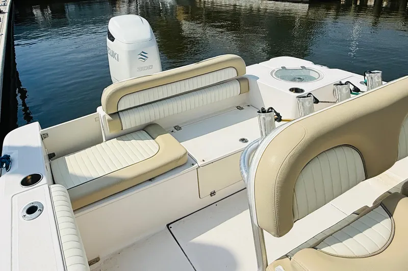 Slide: The Image of 2018 Sea Born LX24 Center Console boat interior with seating and Suzuki engine. - 10