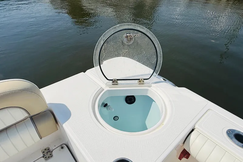 Slide: The Image of 2018 Sea Born LX24 Center Console boat with open livewell on calm water. - 11
