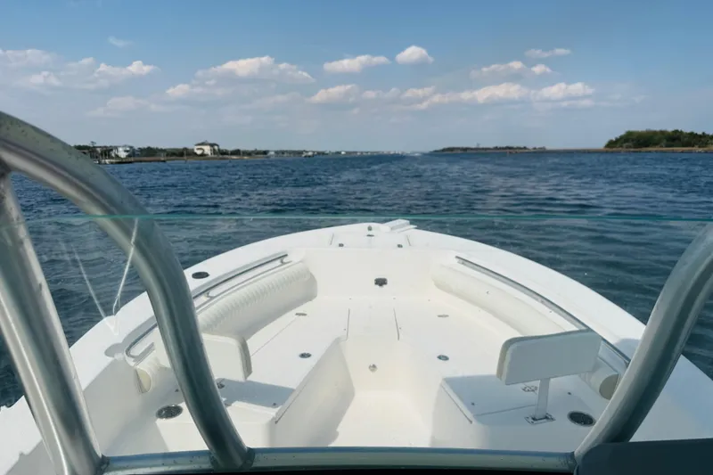 Slide: The Image of 2018 Sea Born LX24 Center Console boat cruising on a calm, scenic waterway. - 13