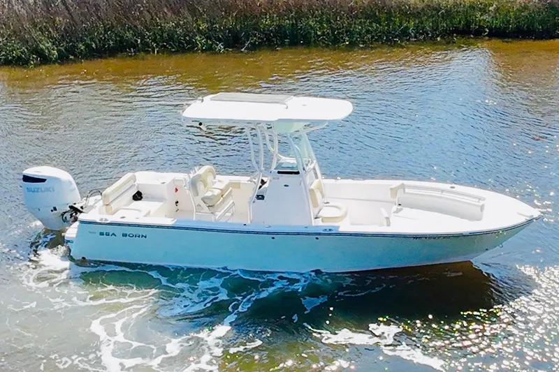 Slide: The Image of 2018 Sea Born LX24 Center Console boat cruising on calm water. - 17