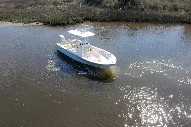 Slide: The Image of 2018 Sea Born LX24 Center Console boat cruising in calm waters. - 19