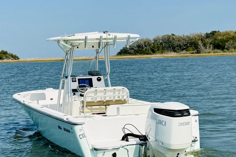 Slide: The Image of 2018 Sea Born LX24 Center Console boat on calm water with Suzuki 300 engine. - 3