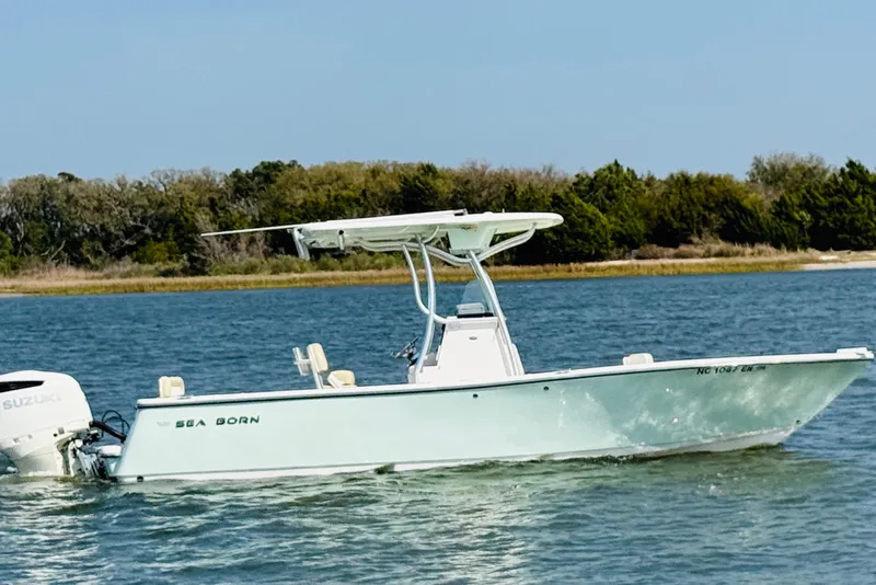 Slide: The Image of 2018 Sea Born LX24 Center Console boat cruising on a calm lake. - 4