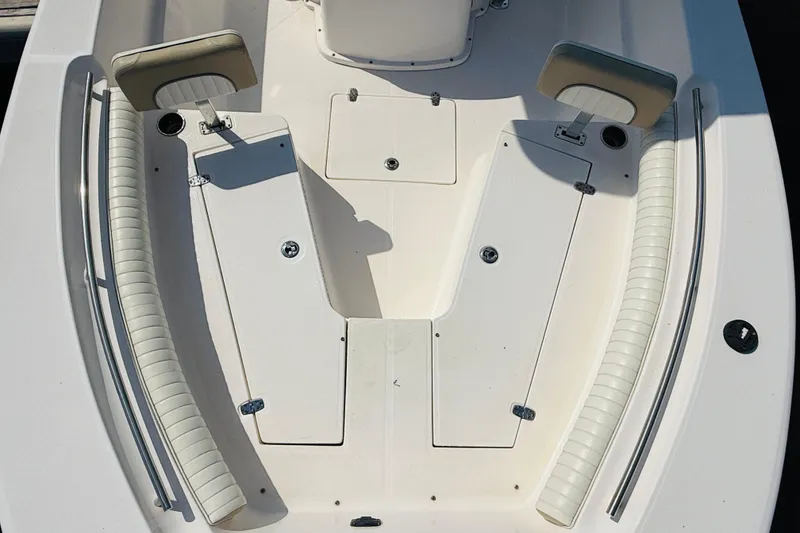 Slide: The Image of 2018 Sea Born LX24 Center Console boat interior with cushioned seating and storage compartments. - 7