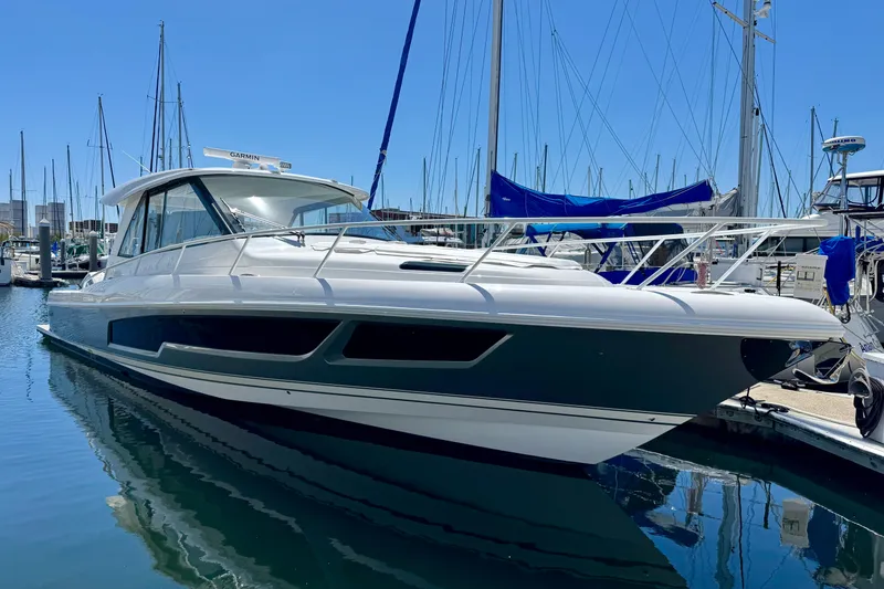 The Image of 2025 Intrepid 50 Evolution yacht docked in a marina under clear blue skies. - 0