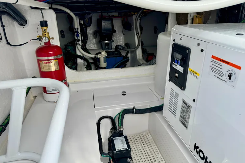 Slide: The Image of Engine room of 2025 Intrepid 50 Evolution with fire extinguisher and Kohler generator. - 11