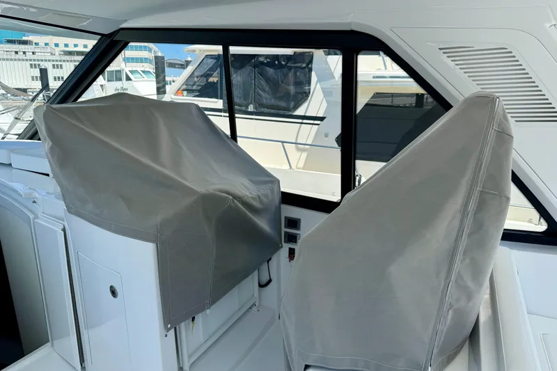 Slide: The Image of Interior of 2025 Intrepid 50 Evolution yacht with covered seats. - 13