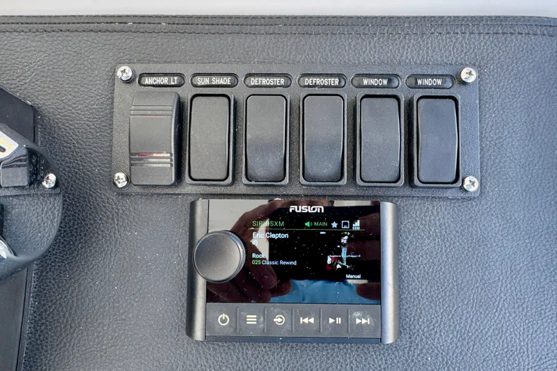 Slide: The Image of Control panel of 2025 Intrepid 50 Evolution with switches and Fusion audio system. - 19