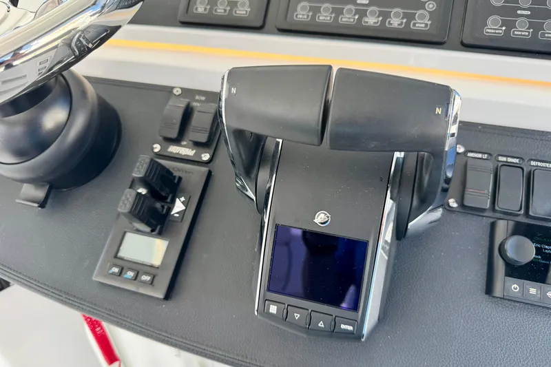 Slide: The Image of Control panel of 2025 Intrepid 50 Evolution boat with throttle and switches. - 20