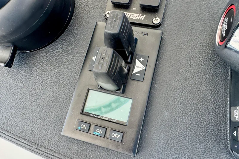 Slide: The Image of Control panel of a 2025 Intrepid 50 Evolution boat with digital display and switches. - 21