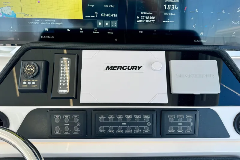 Slide: The Image of Control panel of 2025 Intrepid 50 Evolution boat with Garmin displays and Mercury system. - 22