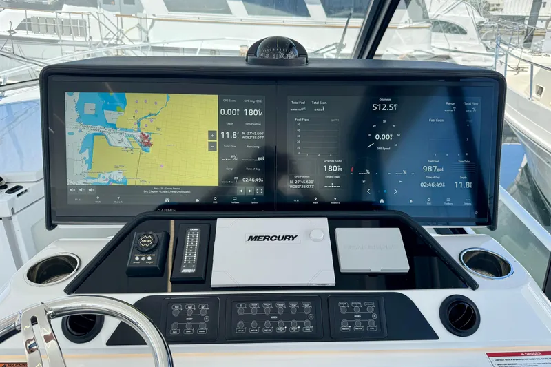 Slide: The Image of Cockpit dashboard of 2025 Intrepid 50 Evolution with navigation and control displays. - 23