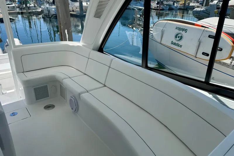 Slide: The Image of Luxurious seating area on 2025 Intrepid 50 Evolution yacht, docked at marina. - 24
